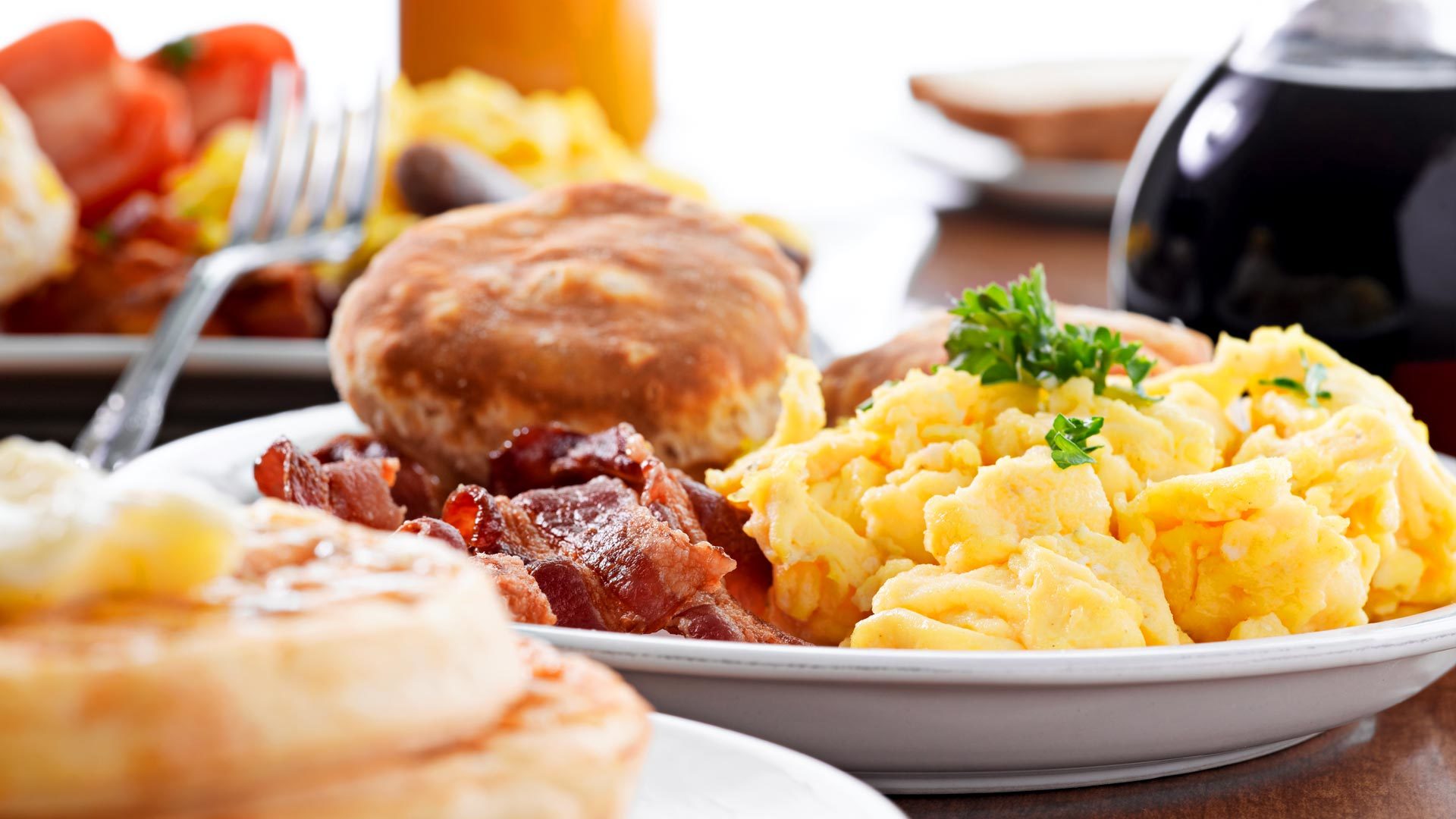 Scrambled eggs, bacon and biscuits breakfast